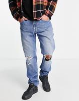 Tommy Jeans Ethan - Ruimvallende distressed jeans met rechte pijpen in mid-wash-Blauw