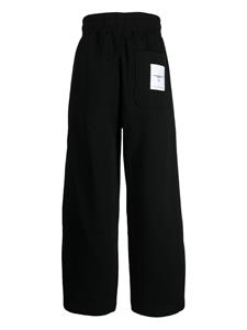 Izzue logo-appliqué wide-leg trousers - Zwart