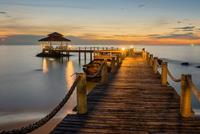 Papermoon Fotobehang Wooded bridge pier between sunset